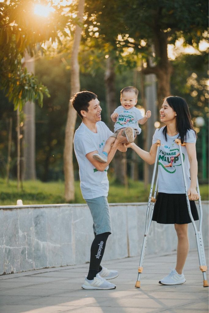 Disabled Couple Guiding Their Baby's First Steps